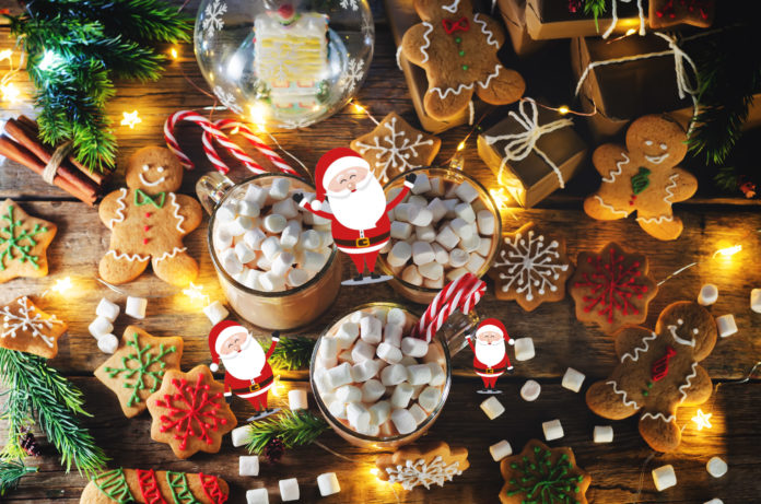 Dark wooden background with cocoa, gingerbread cookies, Christma
